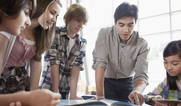 Teacher working with students