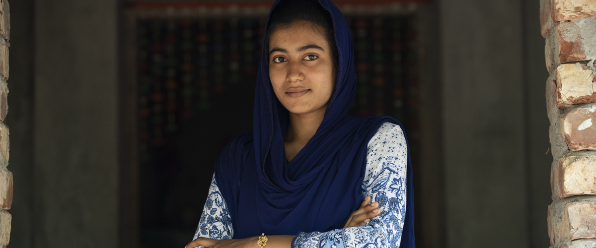 Bithi adolescent group leader staring at camera and standing in a power pose