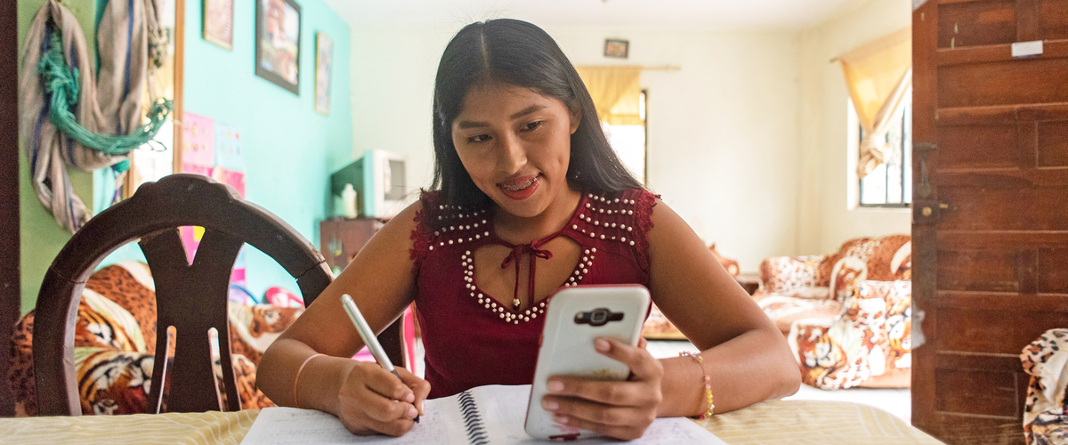 Young woman uses her mobile phone to take part in online training course, version 2