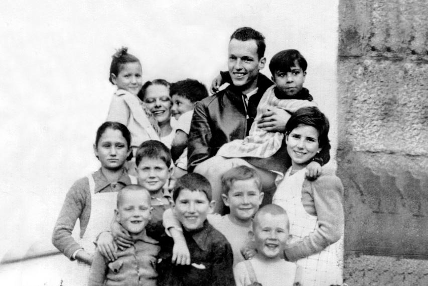 Nick Carter and Esme Odgers surrounded by children in Puigcerda colony 