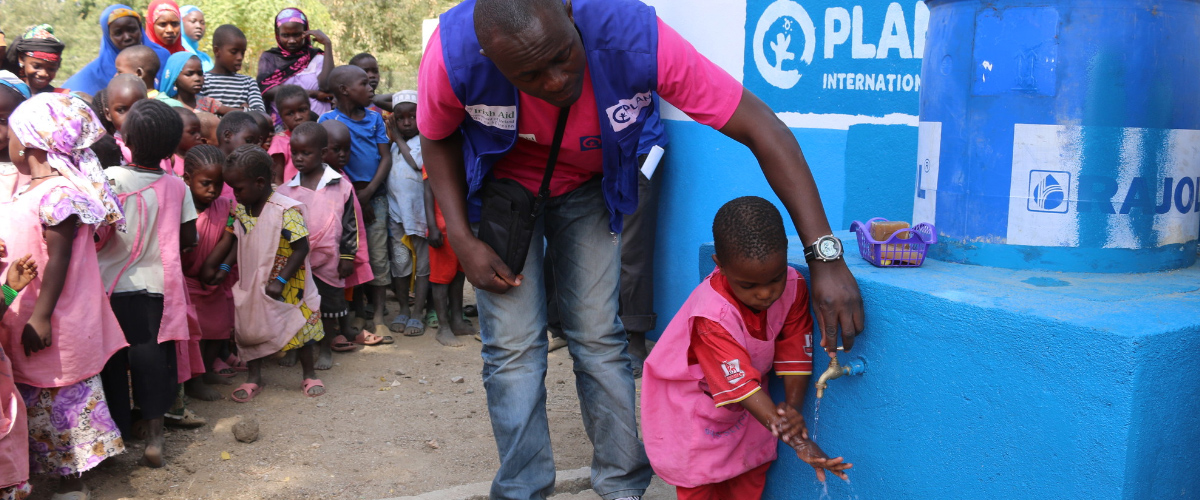 coronavirus-in-africa-young-girl-washing-hands.jpg-900x600