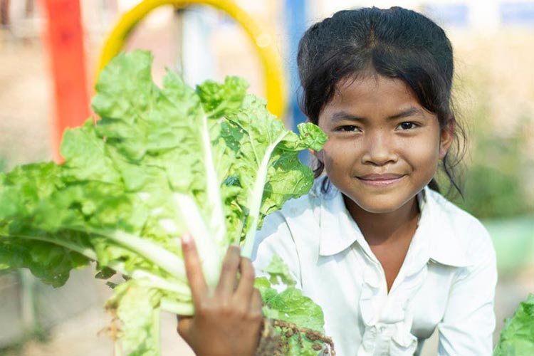 Endless Harvest GOH FY21 - Girl Harvest some of the vegetables she has grown in the school garden