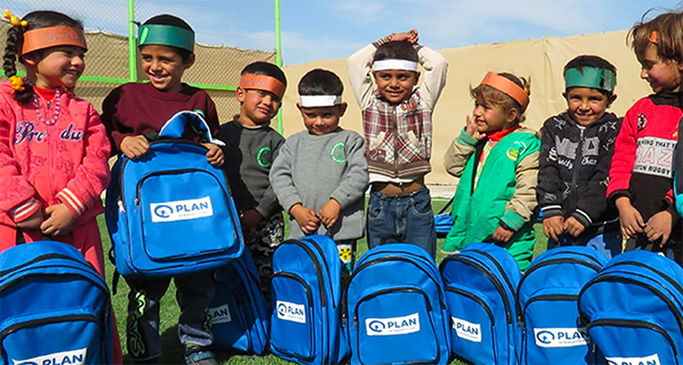 Children wearing Plan backpacks
