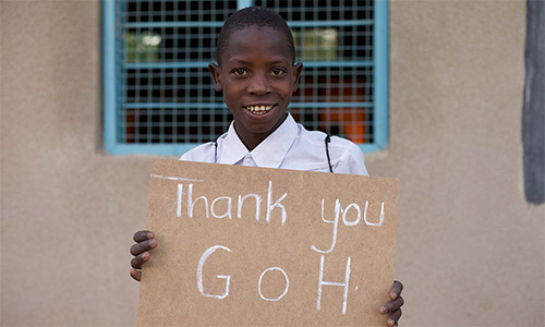GOH Tanzania content collection trip - Girl holding sign 'Thank you GOH'
