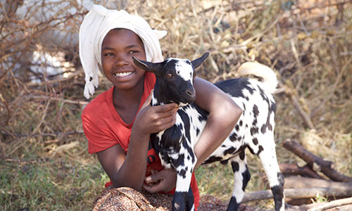 GOH Tanzania content collection trip - girl hugging her goat