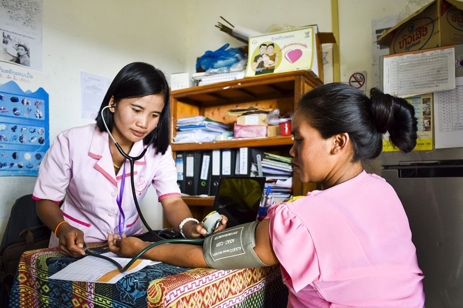 GoH FY 21 Train a female health worker - Midwife Amphai checks pregnant woman's blood pressure at health centre
