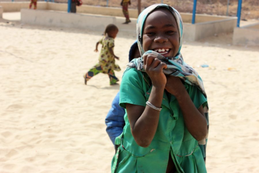 coronavirus-in-africa-smiling-girl-green-top.jpg-900x600